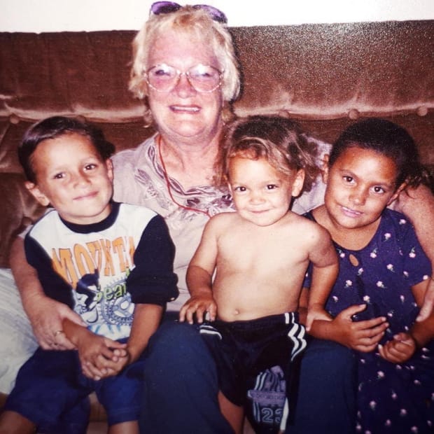 A family photograph from Sam Powell-Pepper's childhood: his grandmother with him and his siblings.