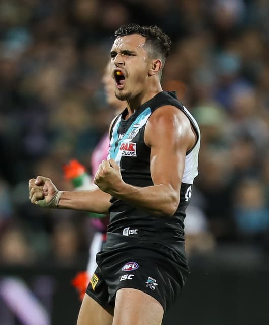 Sam Powell-Pepper clenching both fists and roaring after a goal.