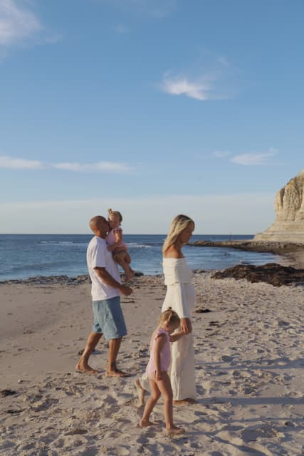 Sam Powell-Pepper with his family on the beach at the end of the day.