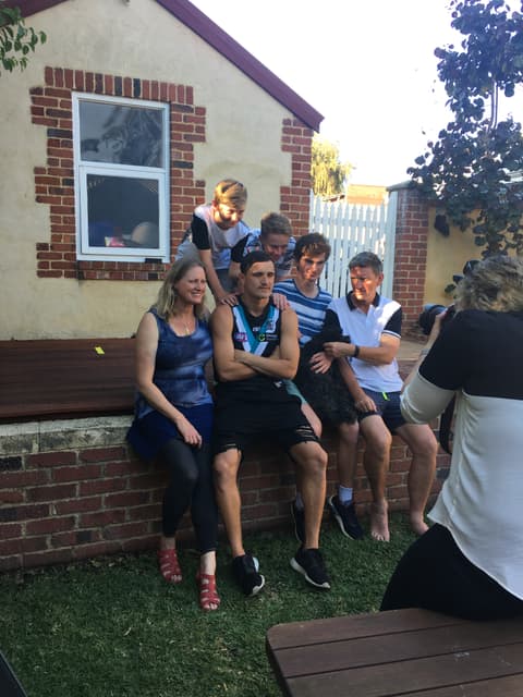 Sam Powell-Pepper with family in the backyard after a game.